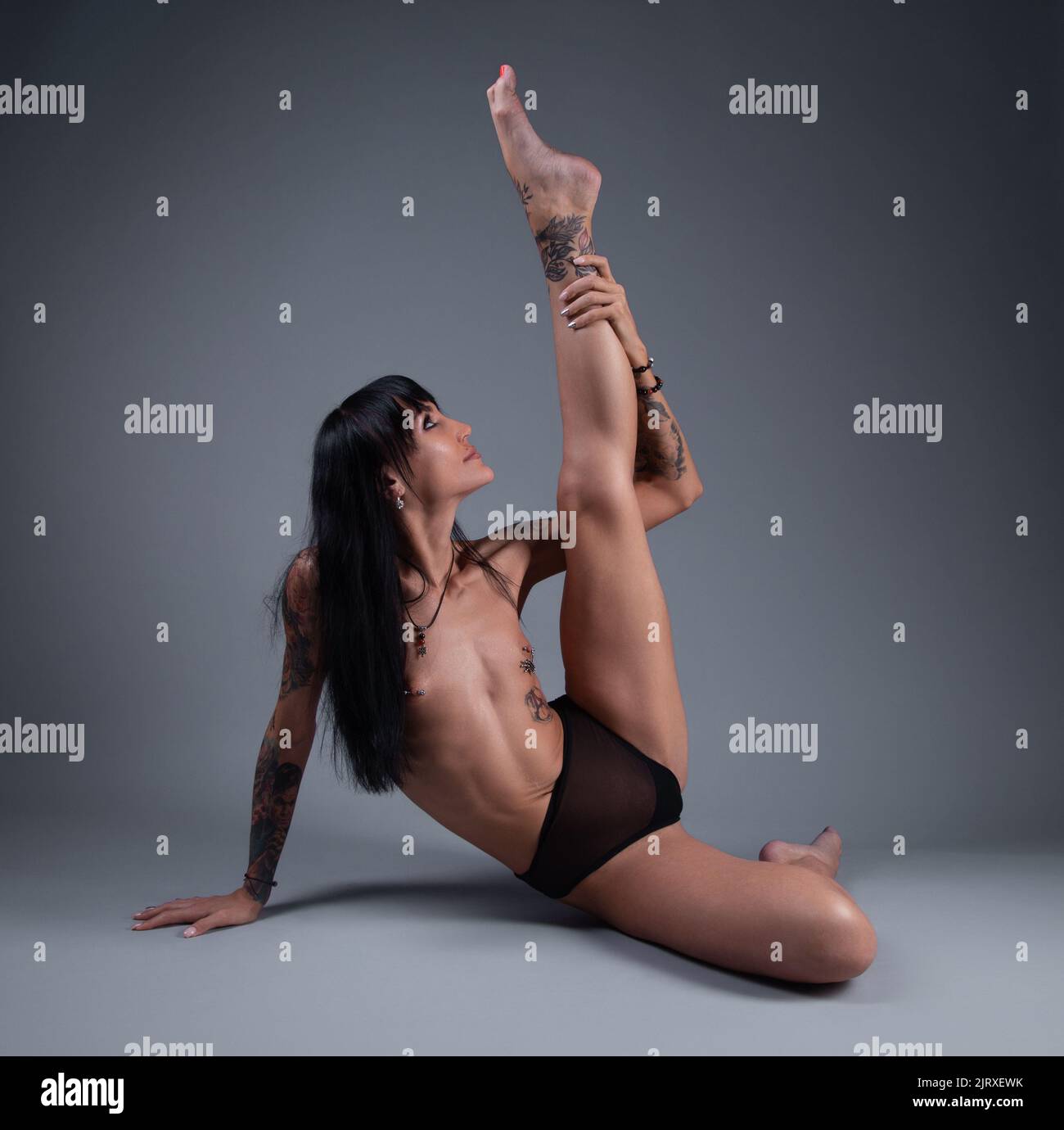 Photo of the topless girl in the panties sitting on the floor Stock Photo