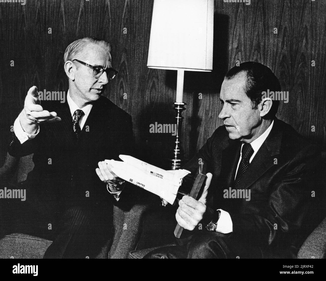 United States President Richard M. Nixon, right, and Dr. James C. Fletcher, Administrator of the National Aeronautics and Space Administration discuss the proposed space shuttle vehicle at San Clemente, California, January 5, 1972. The President announced that day the United States should proceed at once with the development of an entirely new type of space transportation system designed to help transform the space frontier of the 1970s into familiar territory, easily accessible for human endeavor in the 1980s and â90s. Credit: NASA via CNP Stock Photo