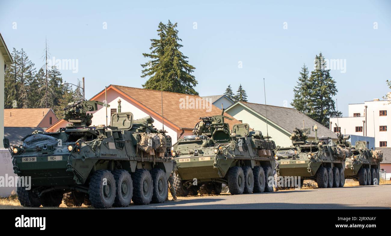 Stryker armored vehicles from 3rd Platoon, Blackhorse Company, 2-3 Infantry Regiment, 1-2 Stryker Brigade Combat Team line up before returning to the control center after a movement-to-contact urban raid exercise on Joint Base Lewis-McChord, Wash., August 24, 2022. The exercise was part of a two-day demonstration event hosted by the Program Executive Office of Ground Combat Systems with the aim of integrating soldier feedback into the development of new military combat technology. (U.S. Army photo by Spc. Chandler Coats, 5th Mobile Public Affairs Detachment) Stock Photo