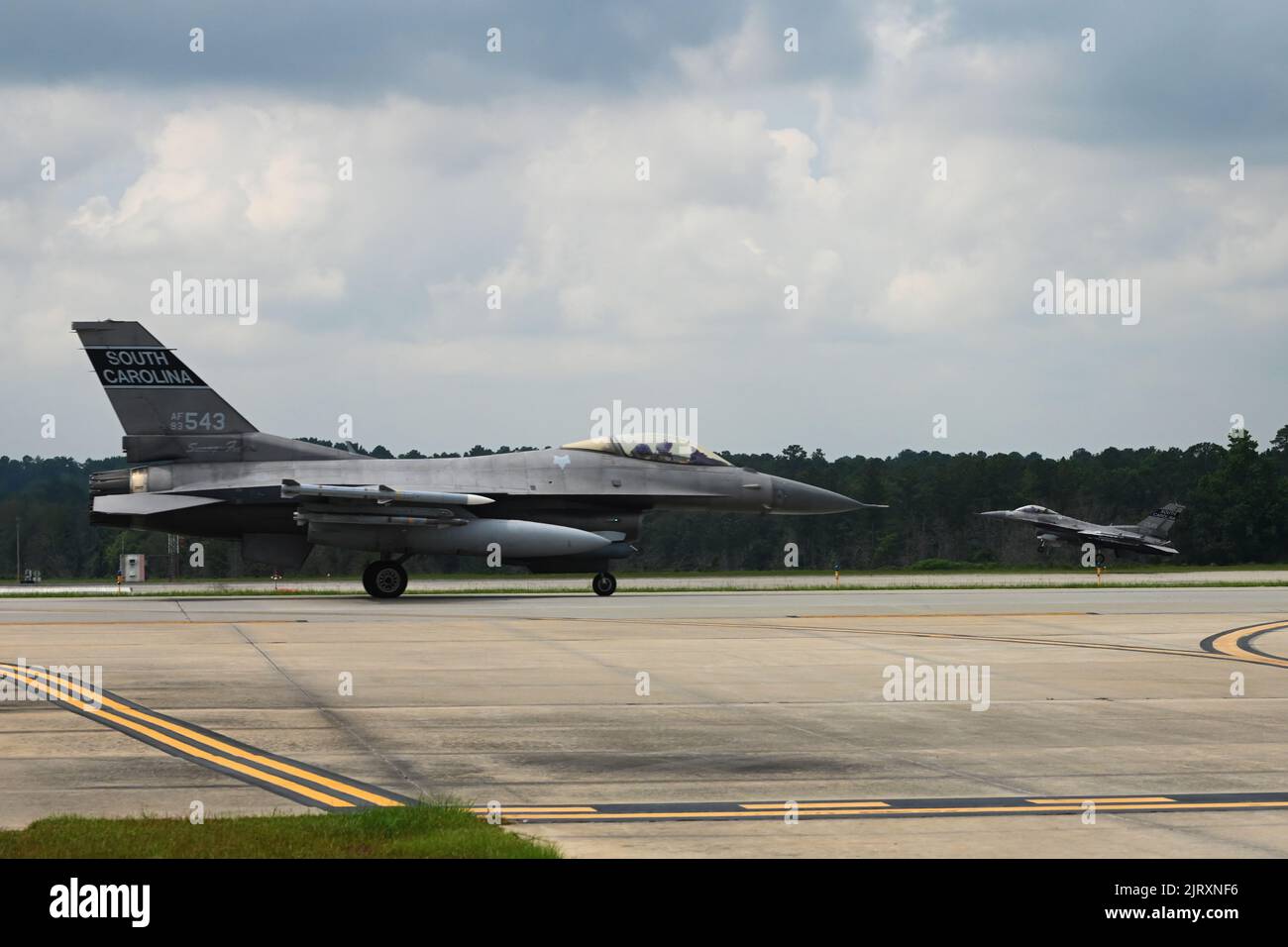 U.S. Air Force F-16 fighter jets assigned to the 169th Fighter Wing from McEntire Joint National Guard Base, South Carolina, touch down and taxi back after conducting routine training flights at the Columbia Metropolitan Airport, South Carolina, August 24, 2022. The 169th Fighter Wing is temporarily flying out of the Columbia Metropolitan Airport while the McEntire Joint National Guard Base runway undergoes construction. (U.S. Air National Guard photo by Airman 1st Class Danielle Dawson) Stock Photo