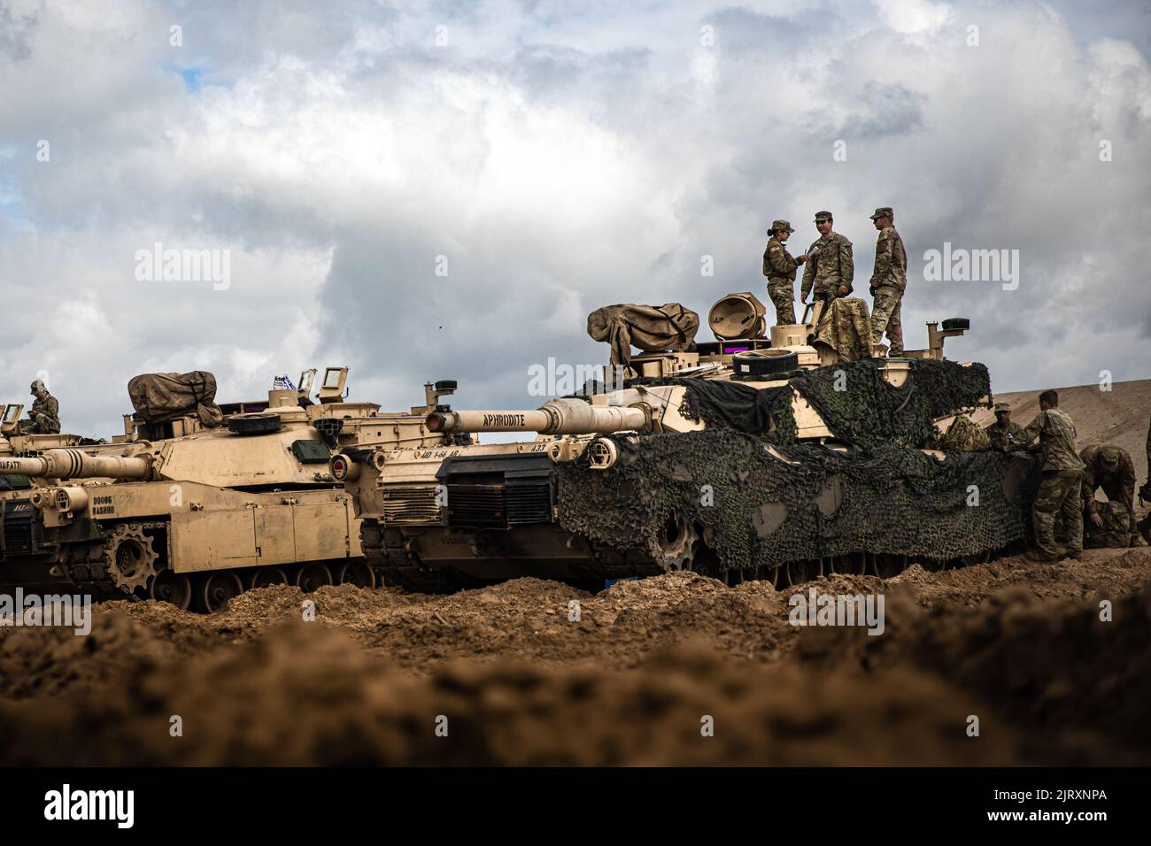 U.S. Army Staff Sgt. Iris Barajas, a tank commander, assigned to the 1st Battalion, 66th Armor Regiment, 3rd Armored Brigade Combat Team, 4th Infantry Division, evaluates her Soldiers as part of a gunnery skills test held at Pabrade, Lithuania, July 19, 2022. (U.S. Army National Guard photo by Sgt. Agustín Montañez) Stock Photo