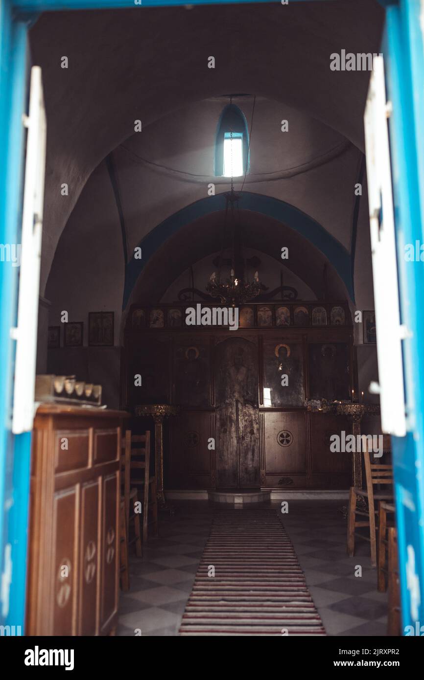 A small Greek Orthodox chapel on Mykonos with a light beam coming through. Stock Photo