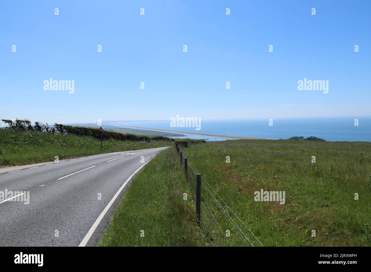 Looking down on Chesil Beach from the road on a beautiful summers day