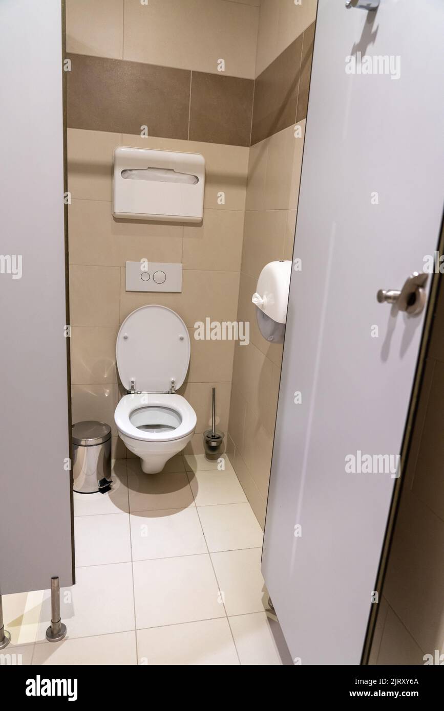 Empty toilet cubicle with open door in a public restroom Stock Photo