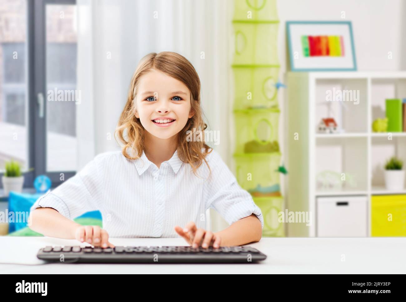 happy student girl with keyboard at home Stock Photo - Alamy