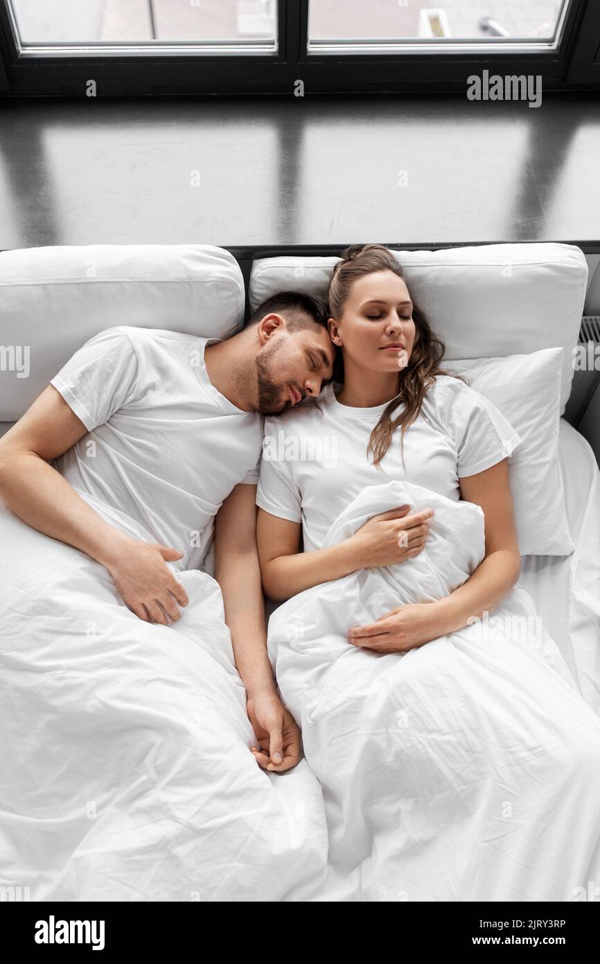 happy couple sleeping in bed at home Stock Photo - Alamy