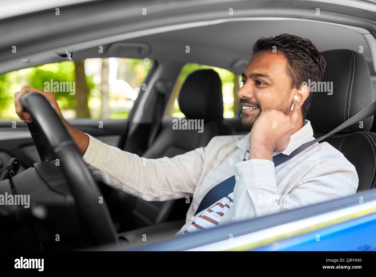 man or driver with wireless earphones driving car Stock Photo Alamy