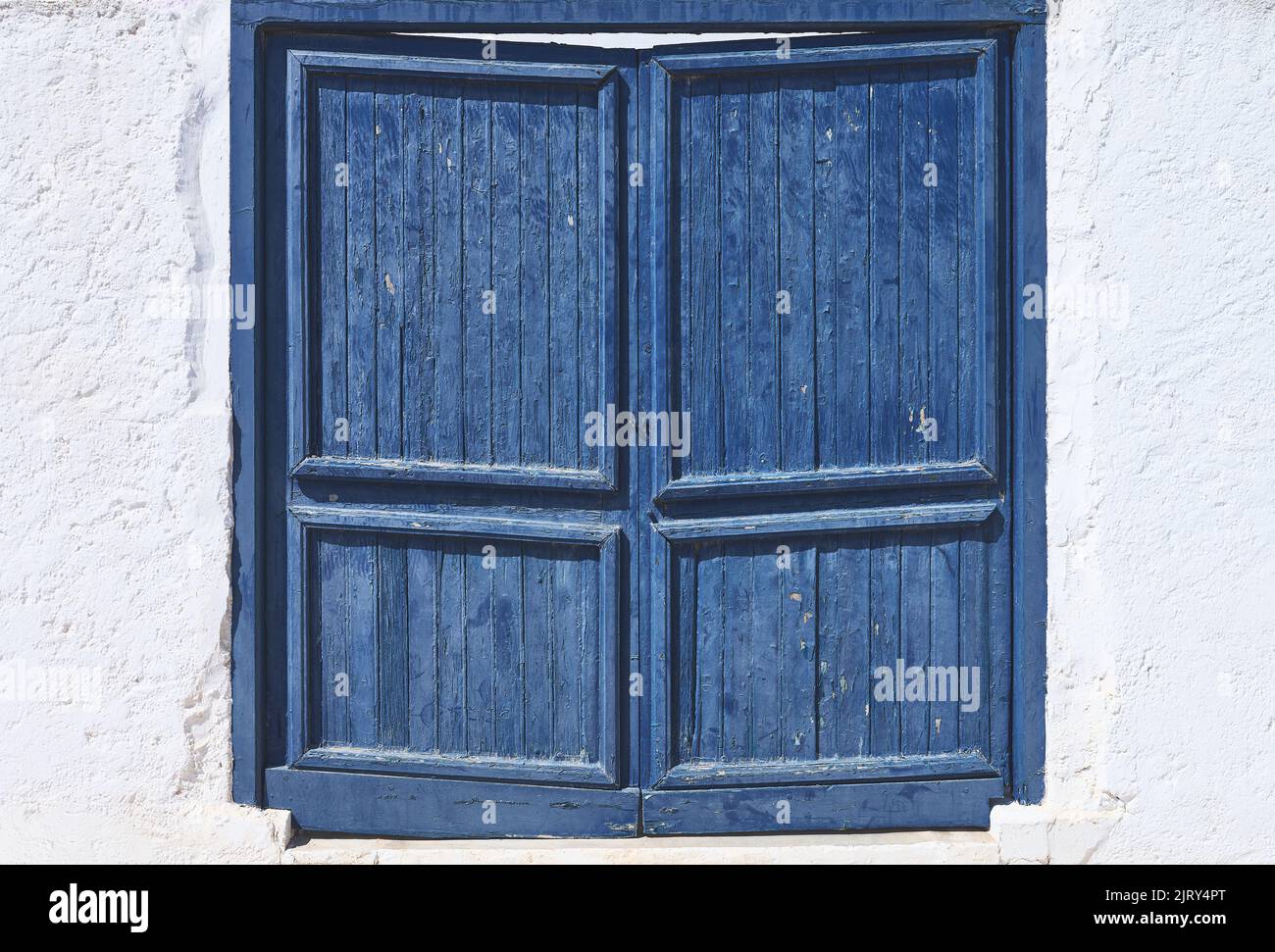 detail of an old blue wooden door on a white wall Stock Photo - Alamy