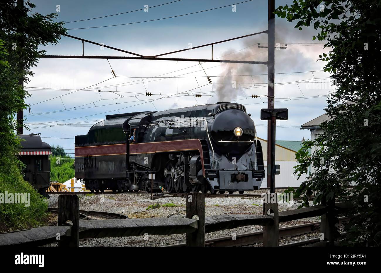 An Antique Restored Steam Engine Approaching Around a Curve Blowing ...