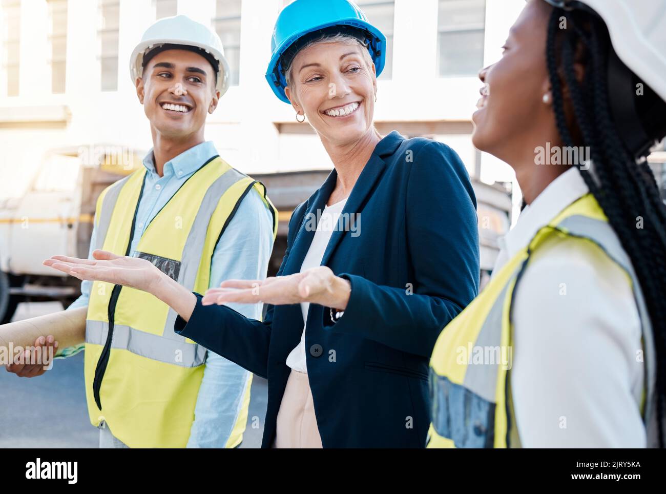 Construction worker, female architect and engineer working as a team on project maintenance on a building site in the city. Teamwork, collaboration Stock Photo