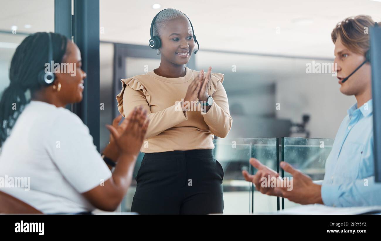 Call center support team clapping hands in congratulations and