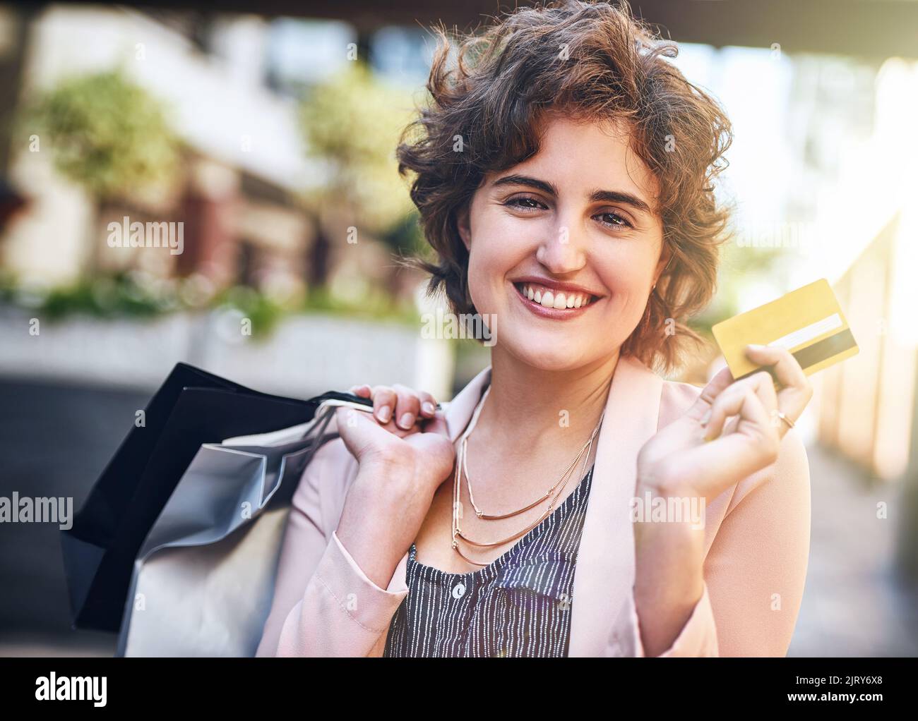 Discover the advantages of a credit card. a woman holding up her credit