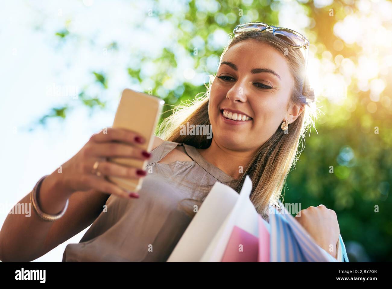 Happy young woman reading messages hi-res stock photography and images ...