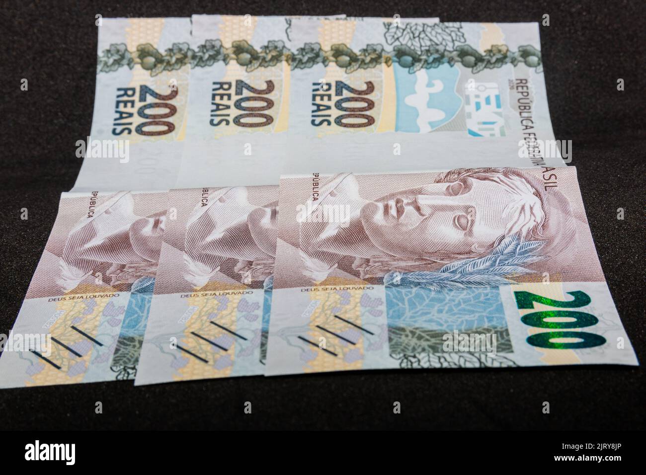 three notes of two hundred reais Brazilian money, totaling six hundred reais, amount paid by the government as emergency aid in the coronavirus pandem Stock Photo