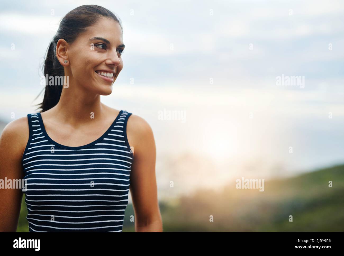 Theres beauty all around us. an attractive young woman enjoying a day outdoors. Stock Photo