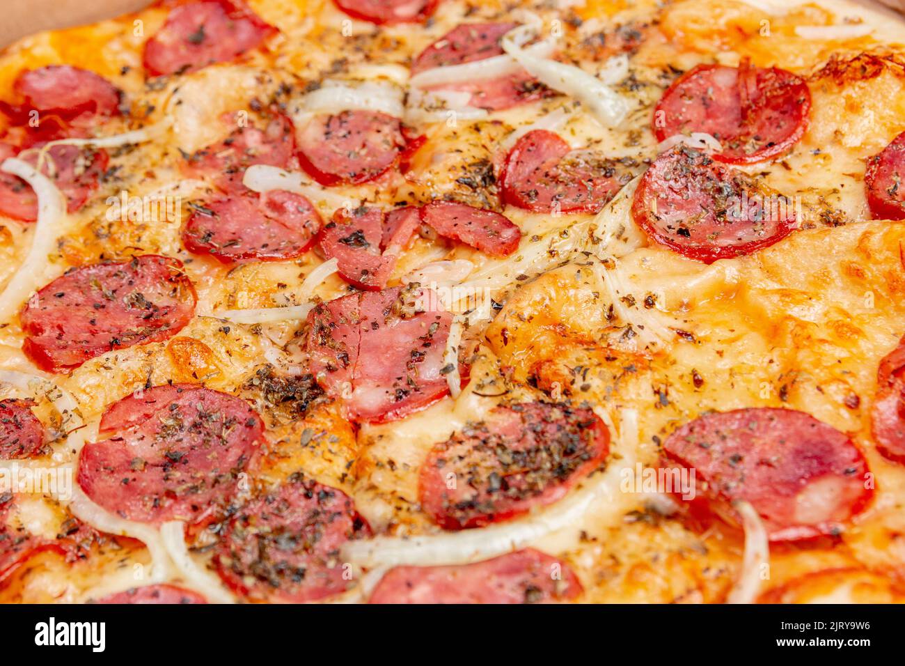 Round pepperoni pizza on a white table in Rio de Janeiro. Stock Photo