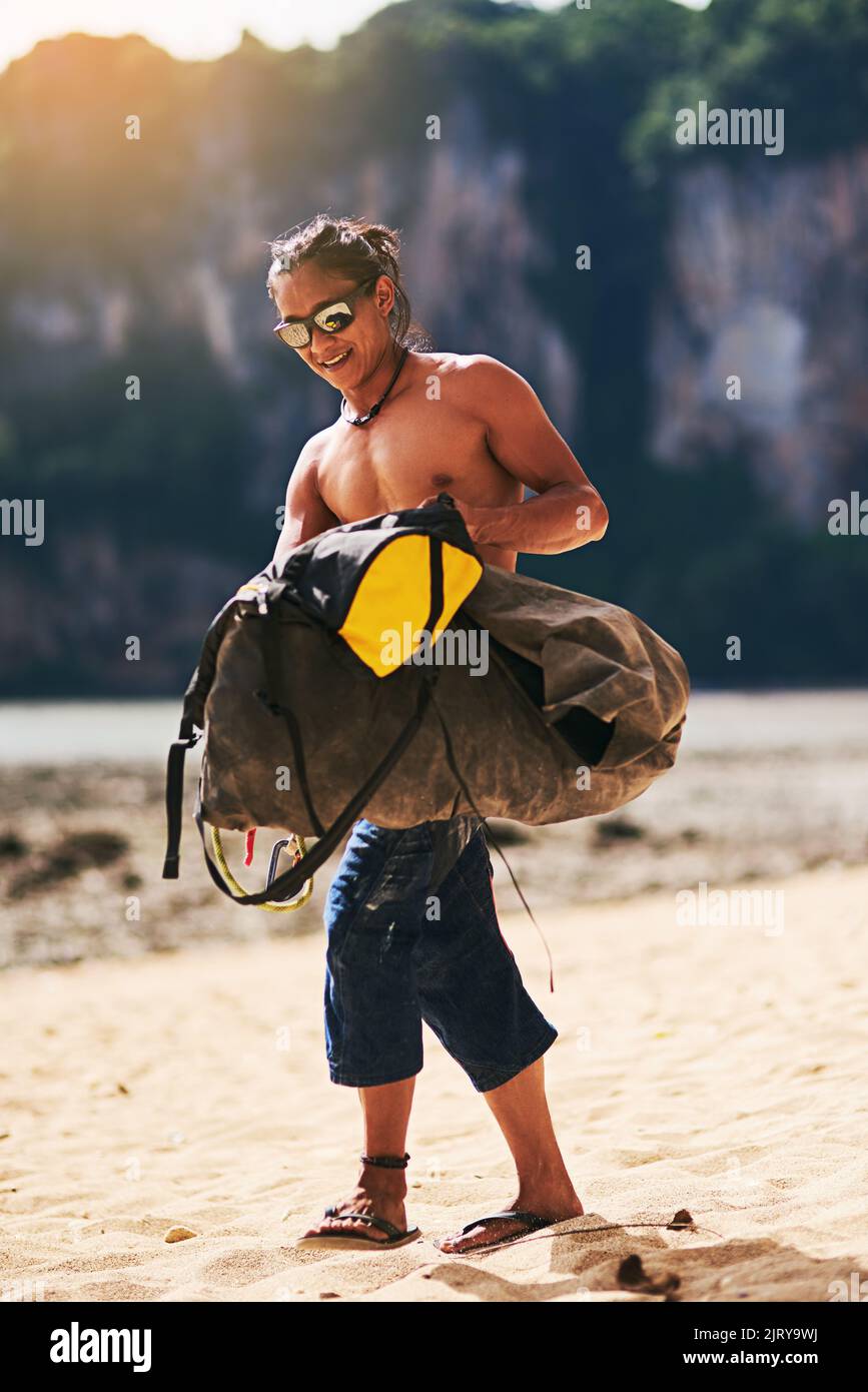 Off to find another mountain to scale. a young man carrying a bag of ...