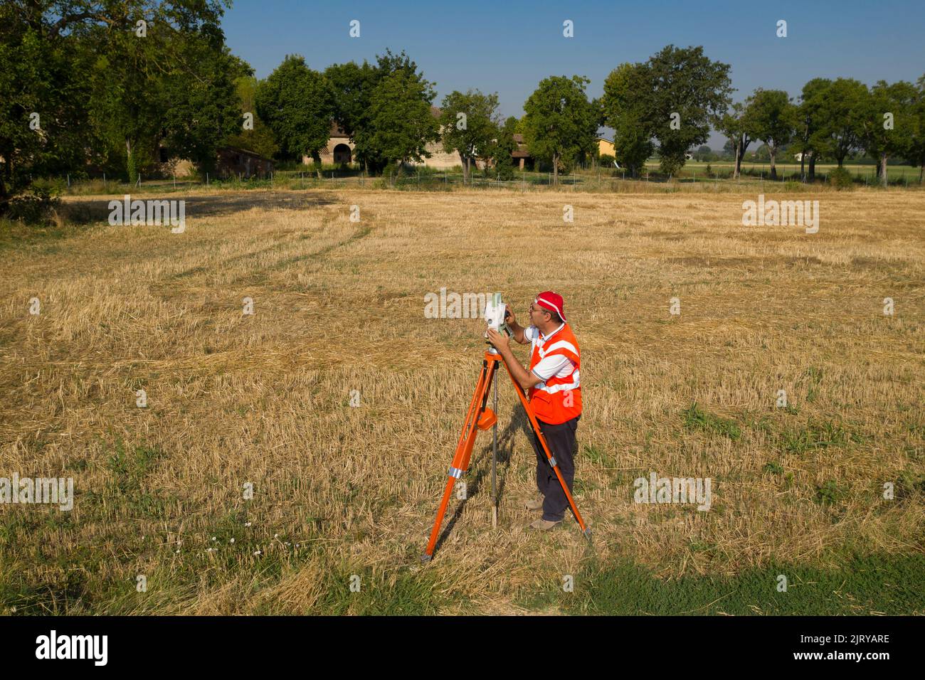 Land surveyor to measure land with  survey equipment camera tool Stock Photo