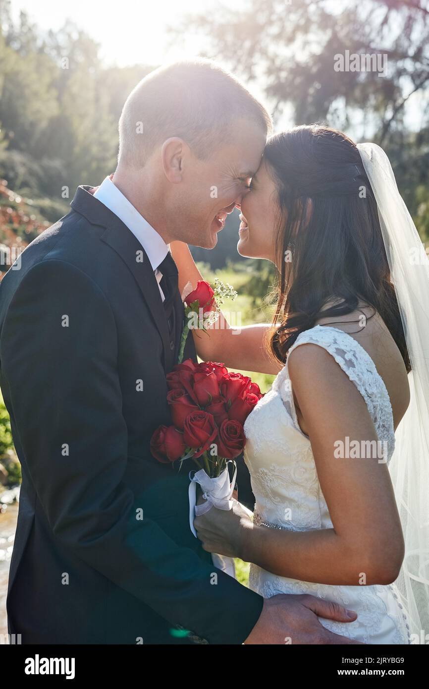 Husband and wife for life. a bride and groom standing outside on their wedding day Stock Photo