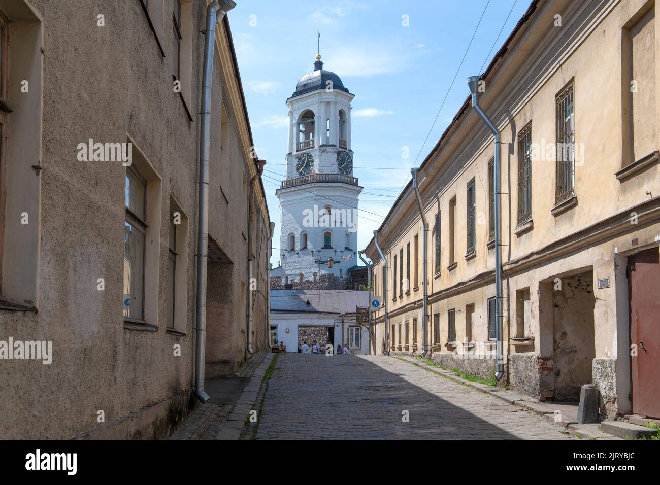 View of the ancient Clock Tower from Vodnaya Zastava street on a sunny July day. Vyborg, Leningrad region. Russia Stock Photo