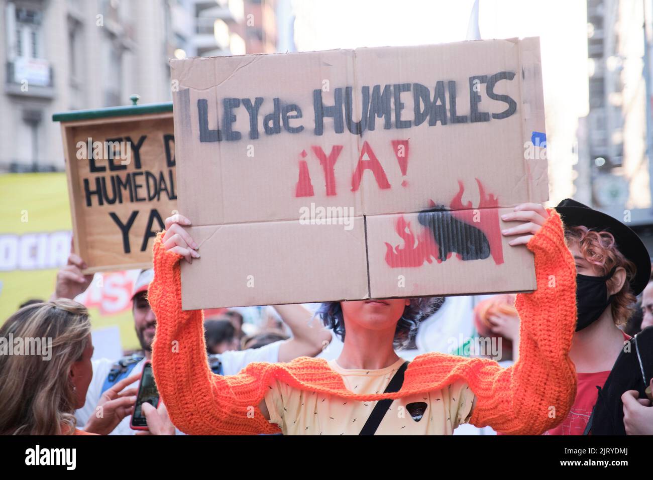 Buenos Aires, Argentina; August 25, 2022: Young people holding posters at an ecological protest against the extractivist system of natural resource ex Stock Photo