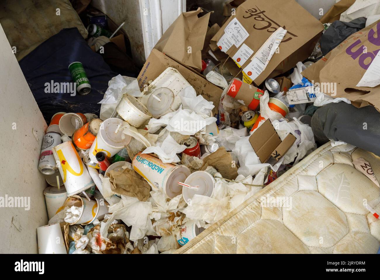 A filthy pile of trash inside a hoarder's apartment. This building has since been demolished Stock Photo