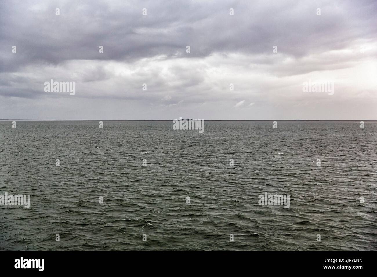 View of the North Sea, dreary weather in autumn, Hallig Langeness on the horizon, cloudy sky, Schleswig-Holstein, Germany Stock Photo