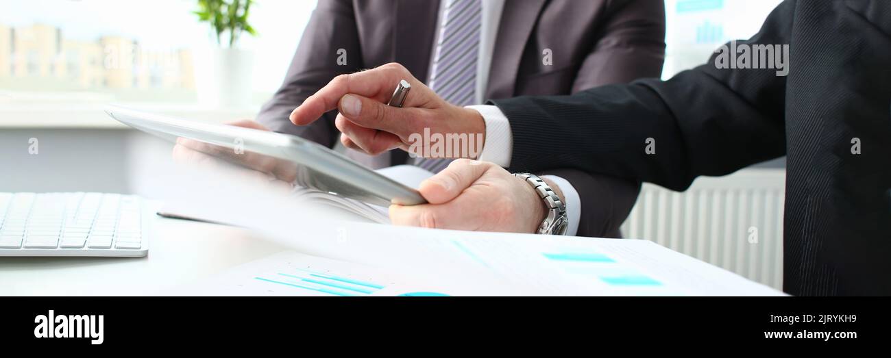 Two businessmen looking and studying analytics and business statistics Stock Photo