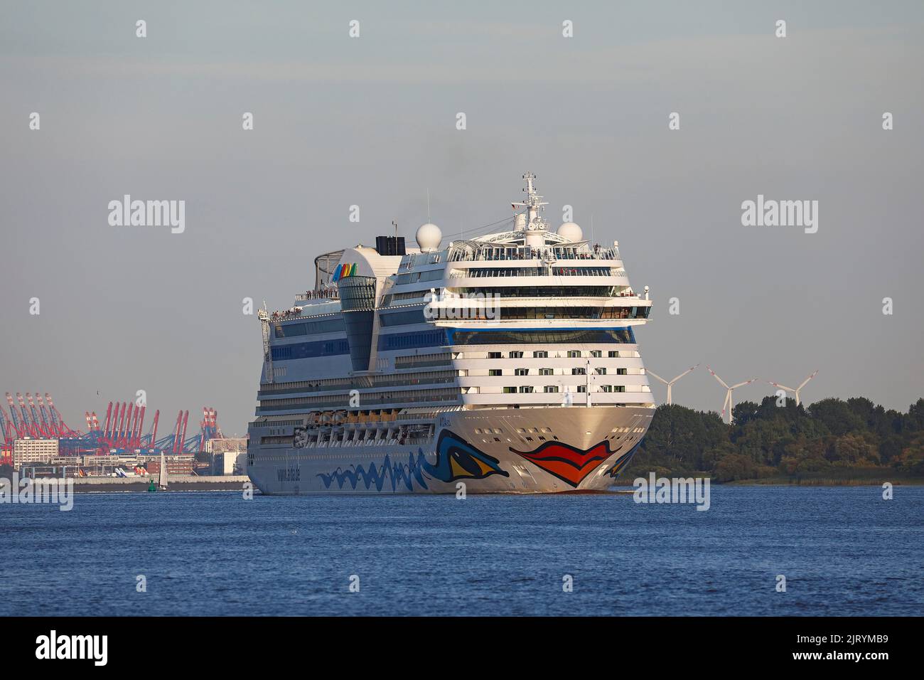 Cruise ship AIDA Sol leaving the port of Hamburg in the evening light on the Elbe, Hamburg, Germany Stock Photo