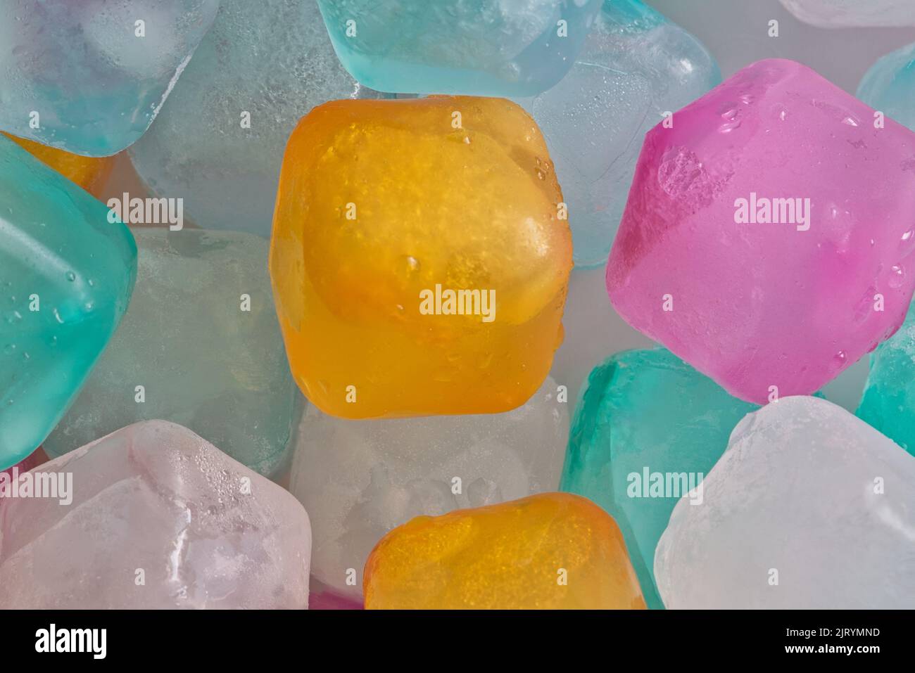 Colorful plastic ice cube blocks, closeup abstract background. Cold refreshing drink concept. Stock Photo