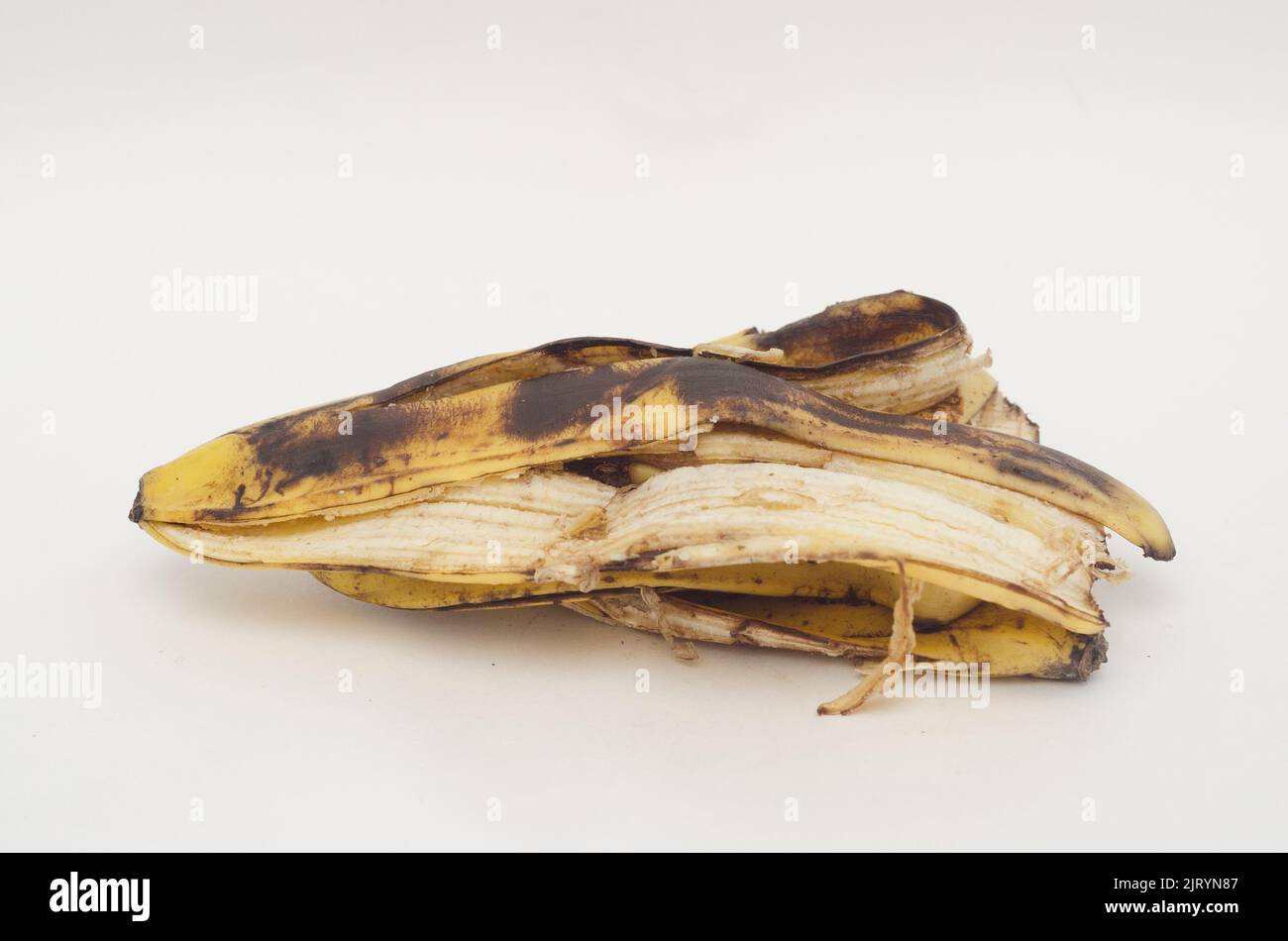a pile of rotten banana skins on white background Stock Photo Alamy