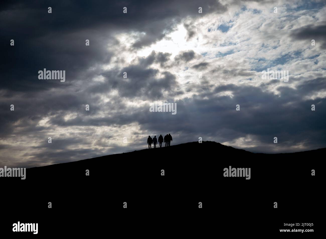 A silhouette of hikers on top of a hill during sunset Stock Photo - Alamy