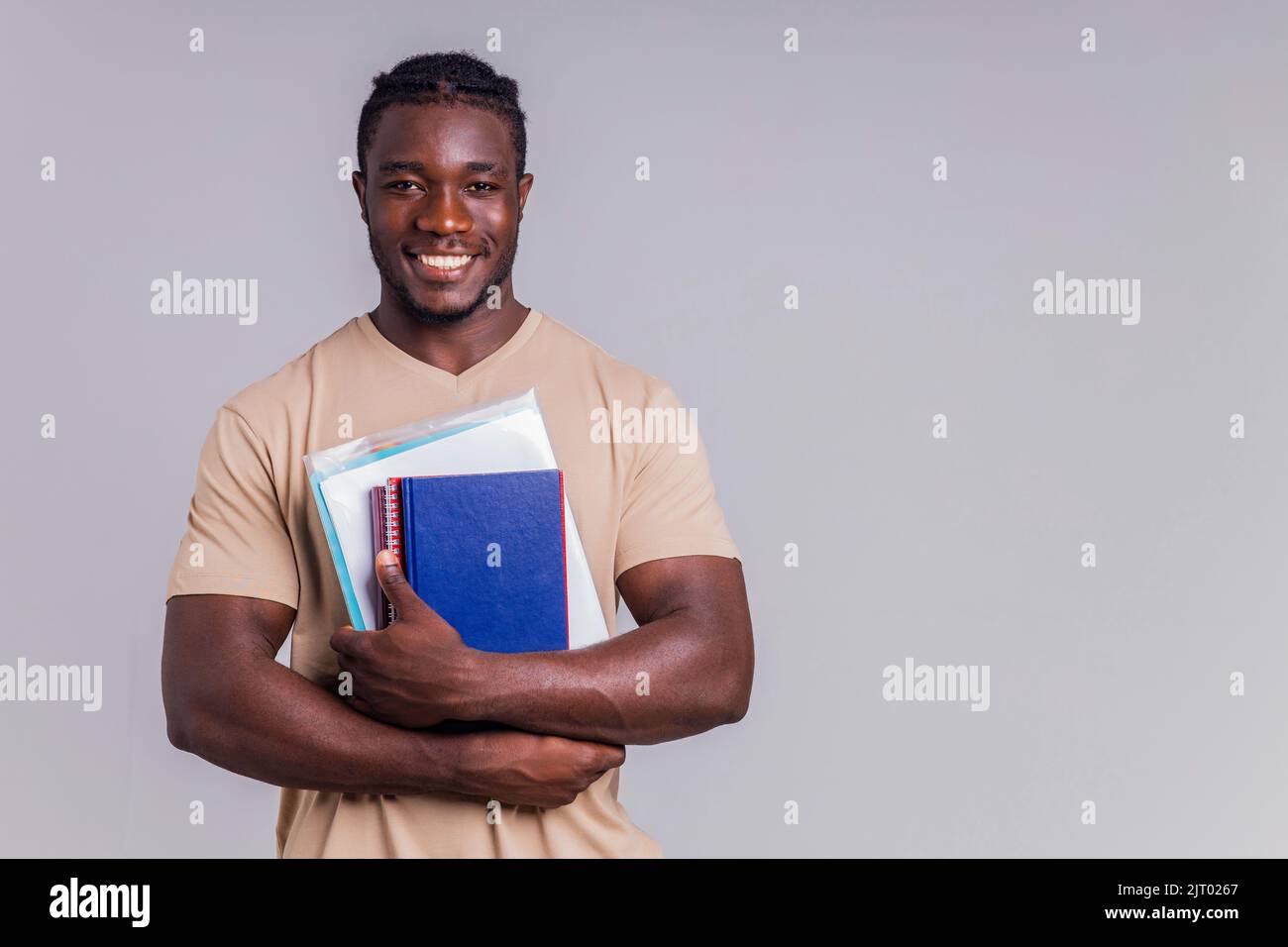 african american man student with backpack in studio smiling at the ...