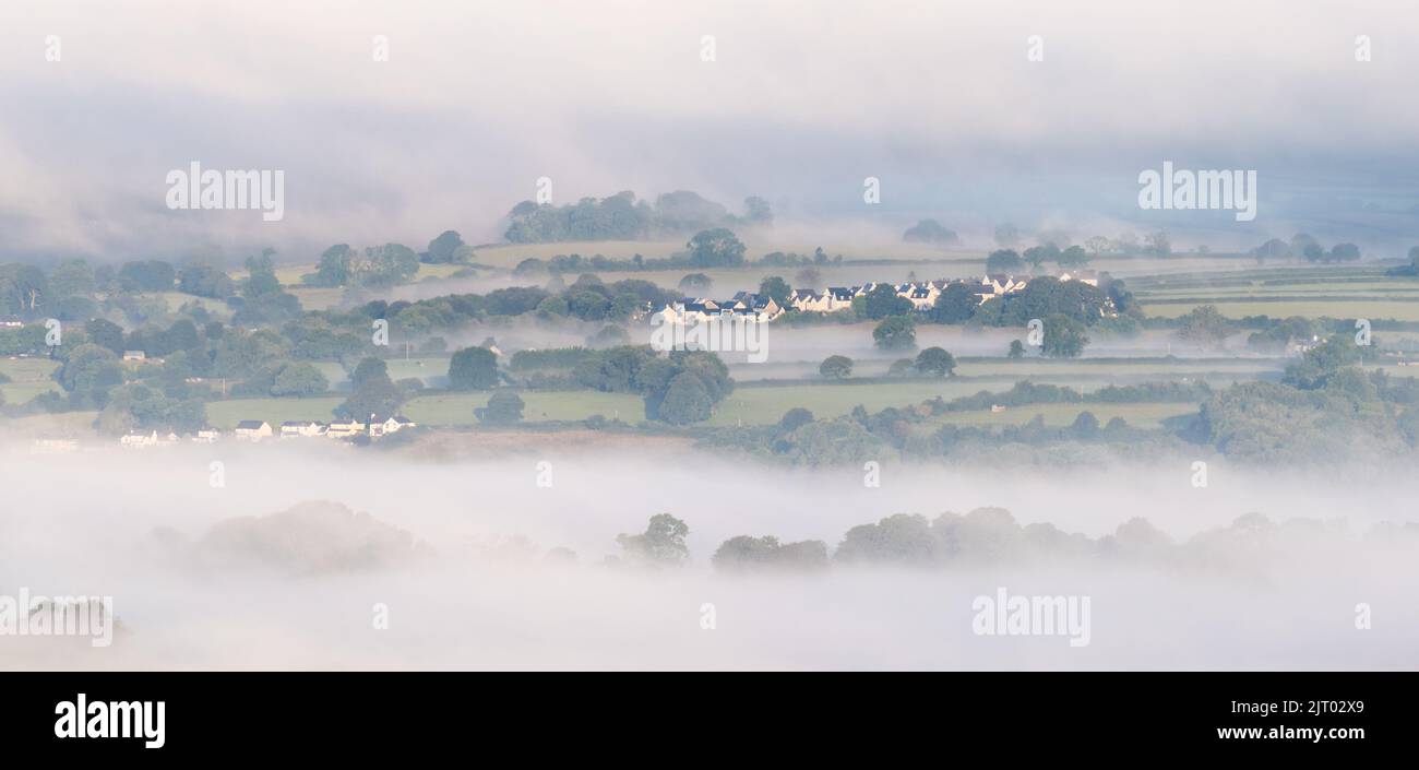 Tavistock, Dartmoor National Park, Devon, UK. 27th Aug, 2022. UK Weather: The elegant Market town of Tavistock, which lies on the edge of Dartmoor National Park, emerges from the mist just after sunrise. After weeks of hot and muggy weather, the weather has taken on a decidely autumnal feel. Credit: Celia McMahon/Alamy Live News Stock Photo