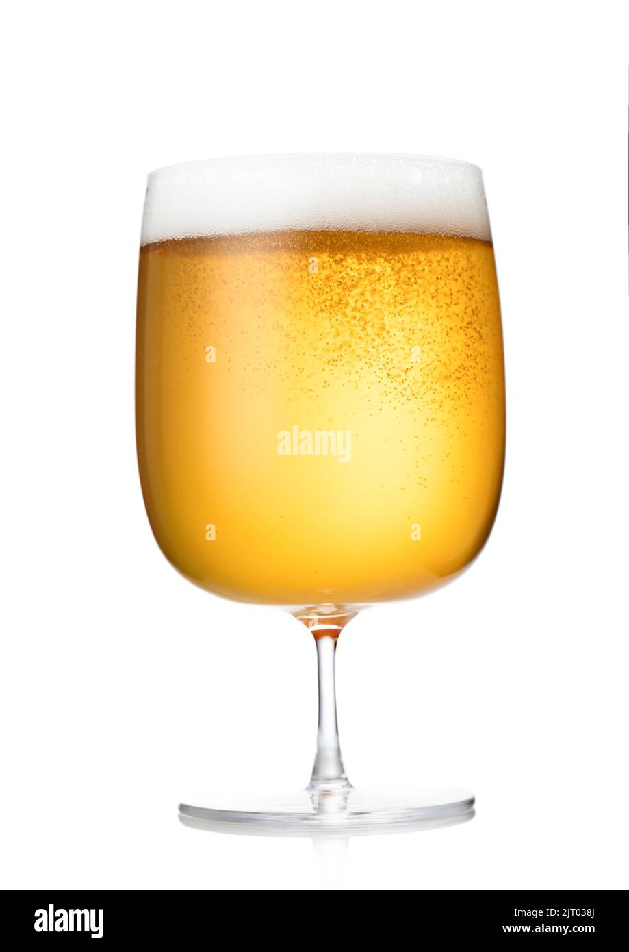 Pint of lager craft beer with bubbles in luxury crystal glass on white. Stock Photo