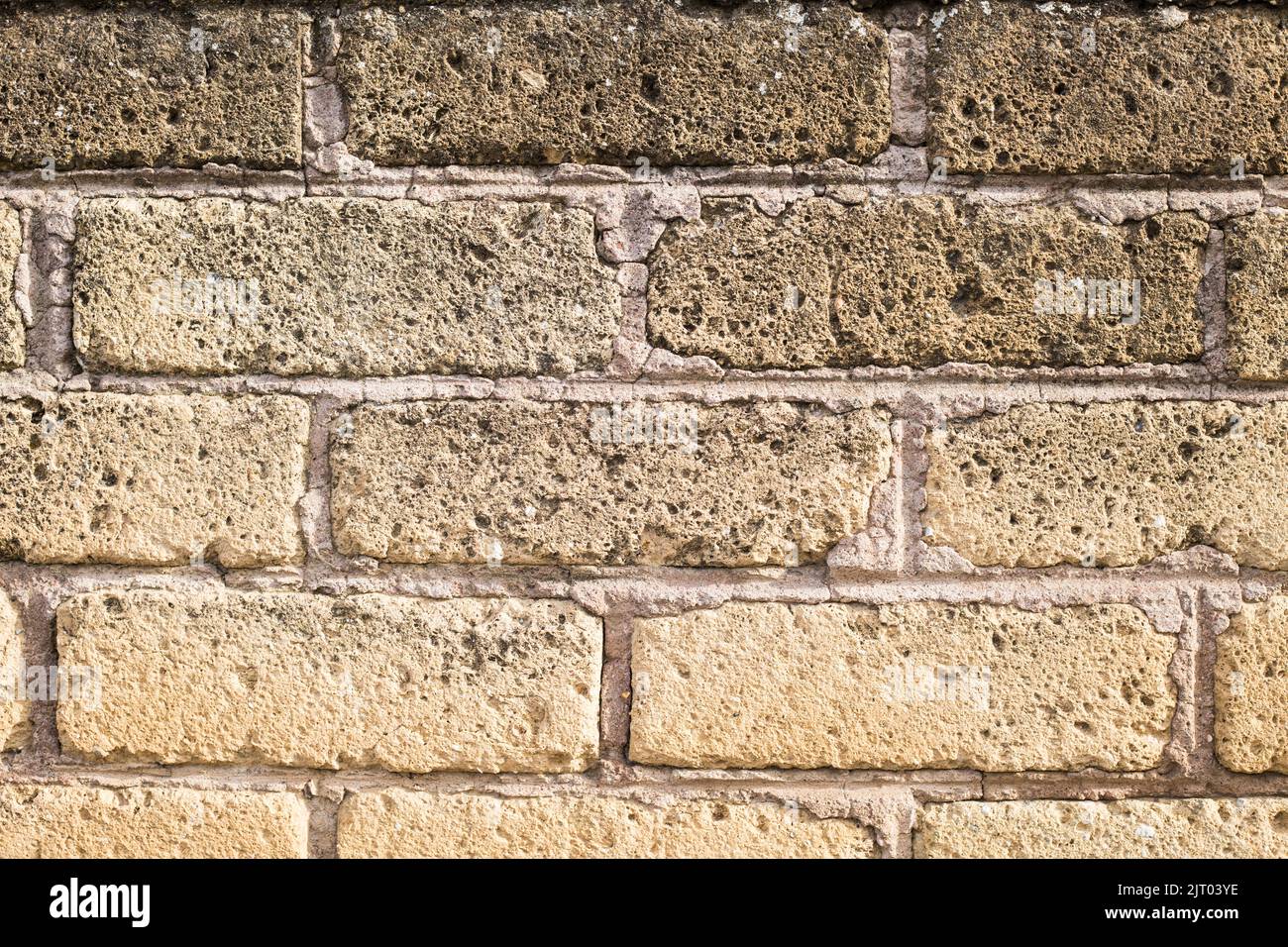 light yellow brick wall background. Horizontal photo of beige rock