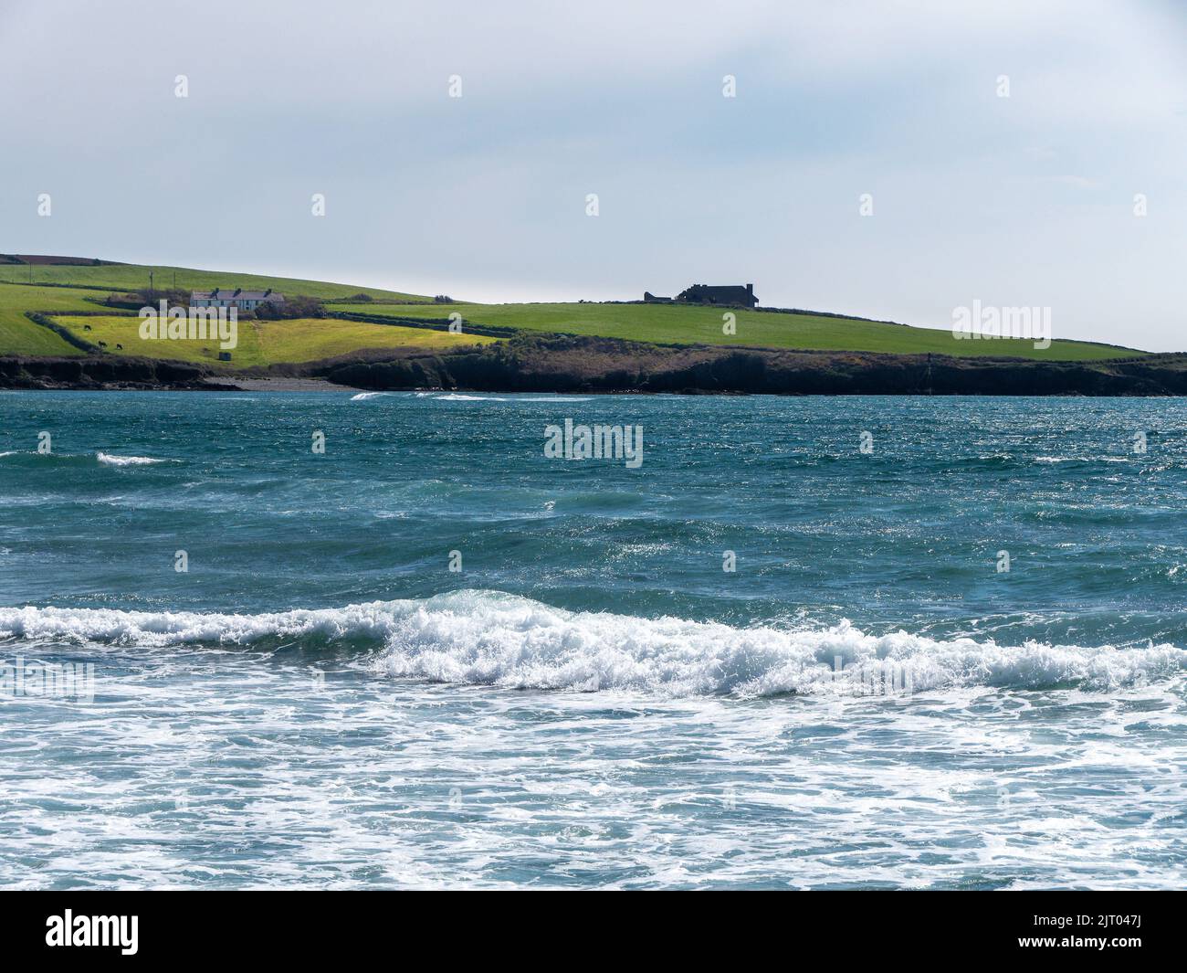 The Atlantic Ocean in the Ireland. Beautiful seascape, sunny warm weather. A beautiful place on the seashore. The blue water of the Celtic Sea. Green Stock Photo