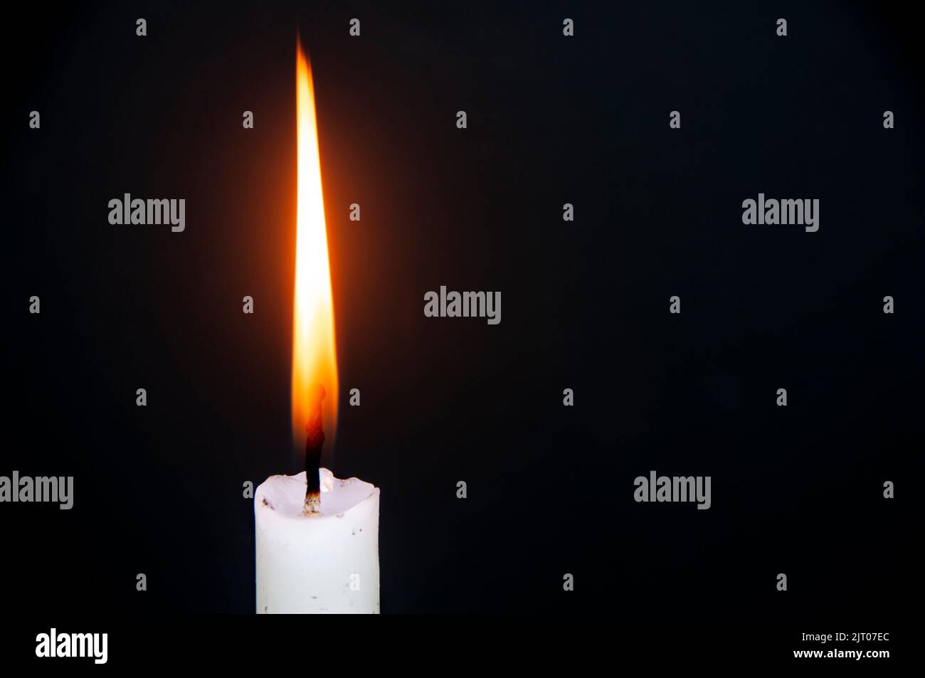 Candle light burning brightly with customizable space for text or ideas. Copy space. Stock Photo