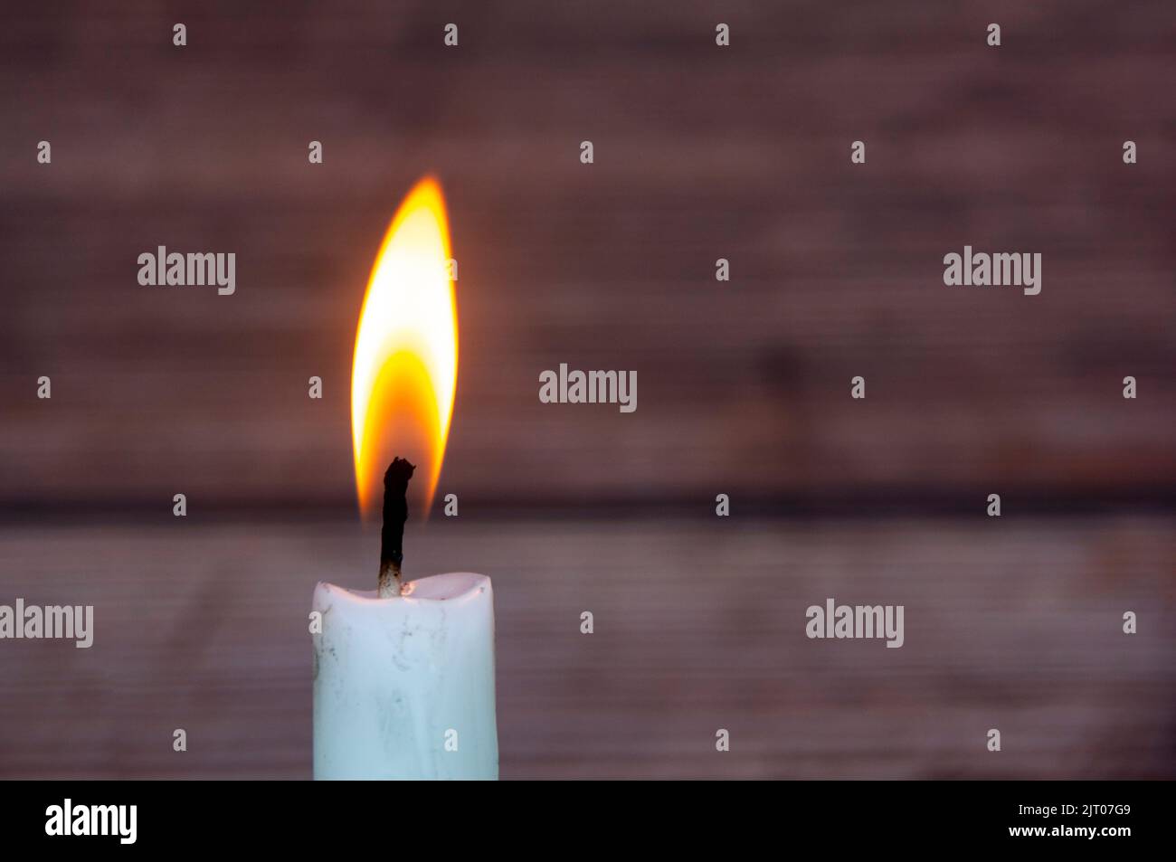 Candle light burning brightly with customizable space for text or ideas. Copy space. Stock Photo