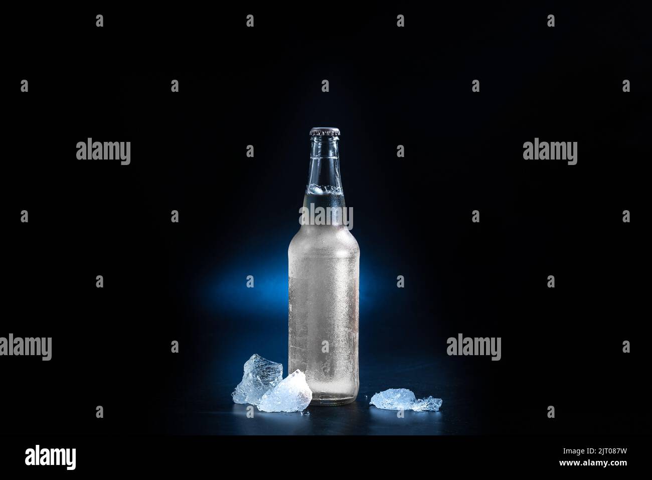 glass bottle with a hard seltzer drink on a black background. Bottle