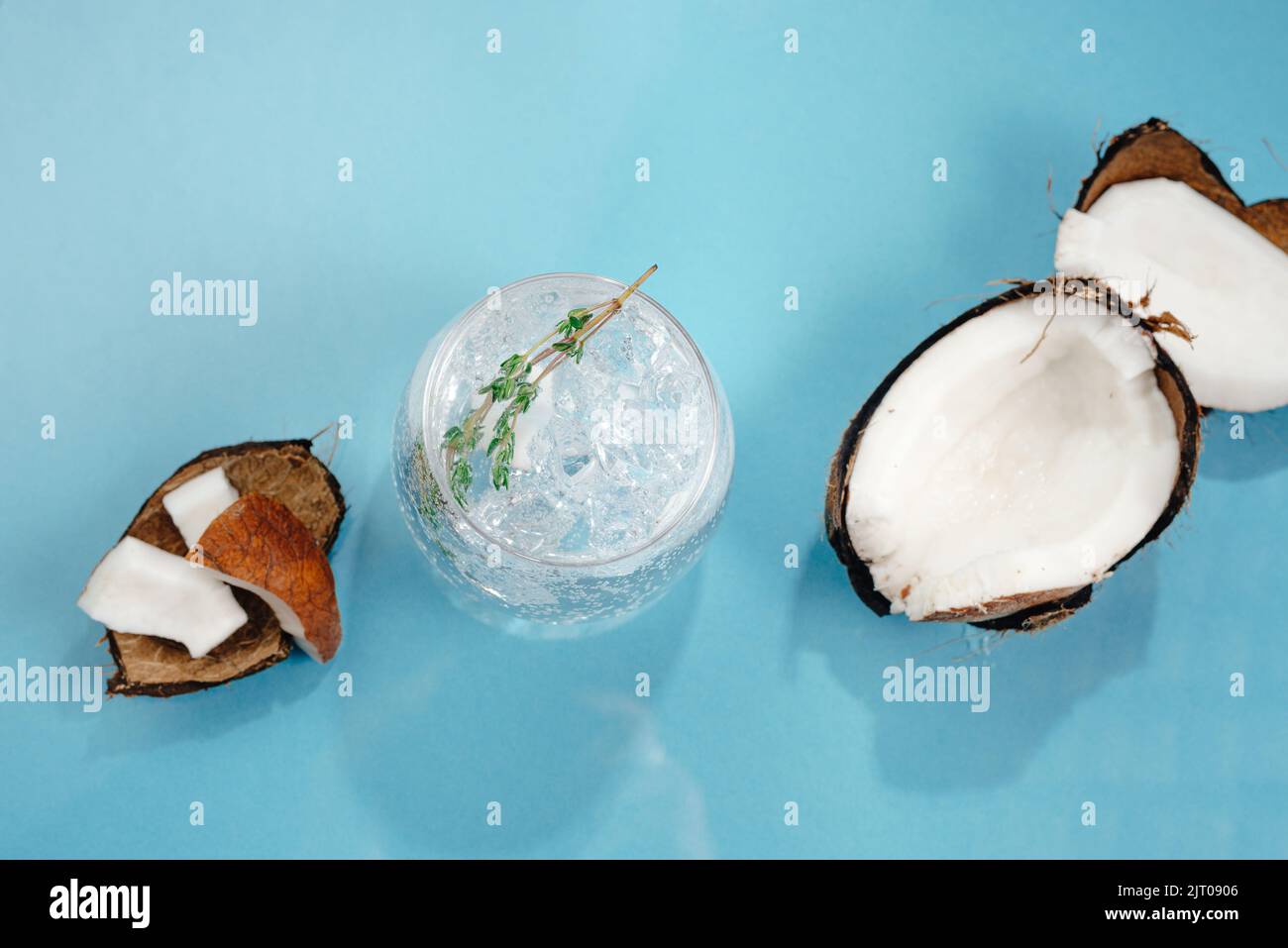 Alcoholic cocktail hard seltzer with coconut on blue background Stock
