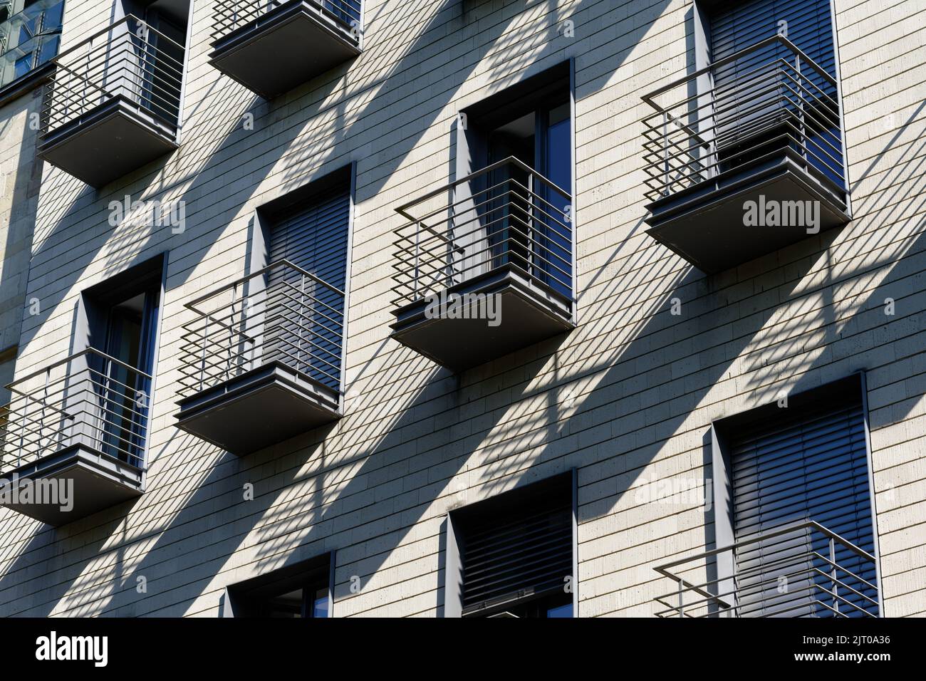 very small balconies on a residential home cast shadows Stock Photo