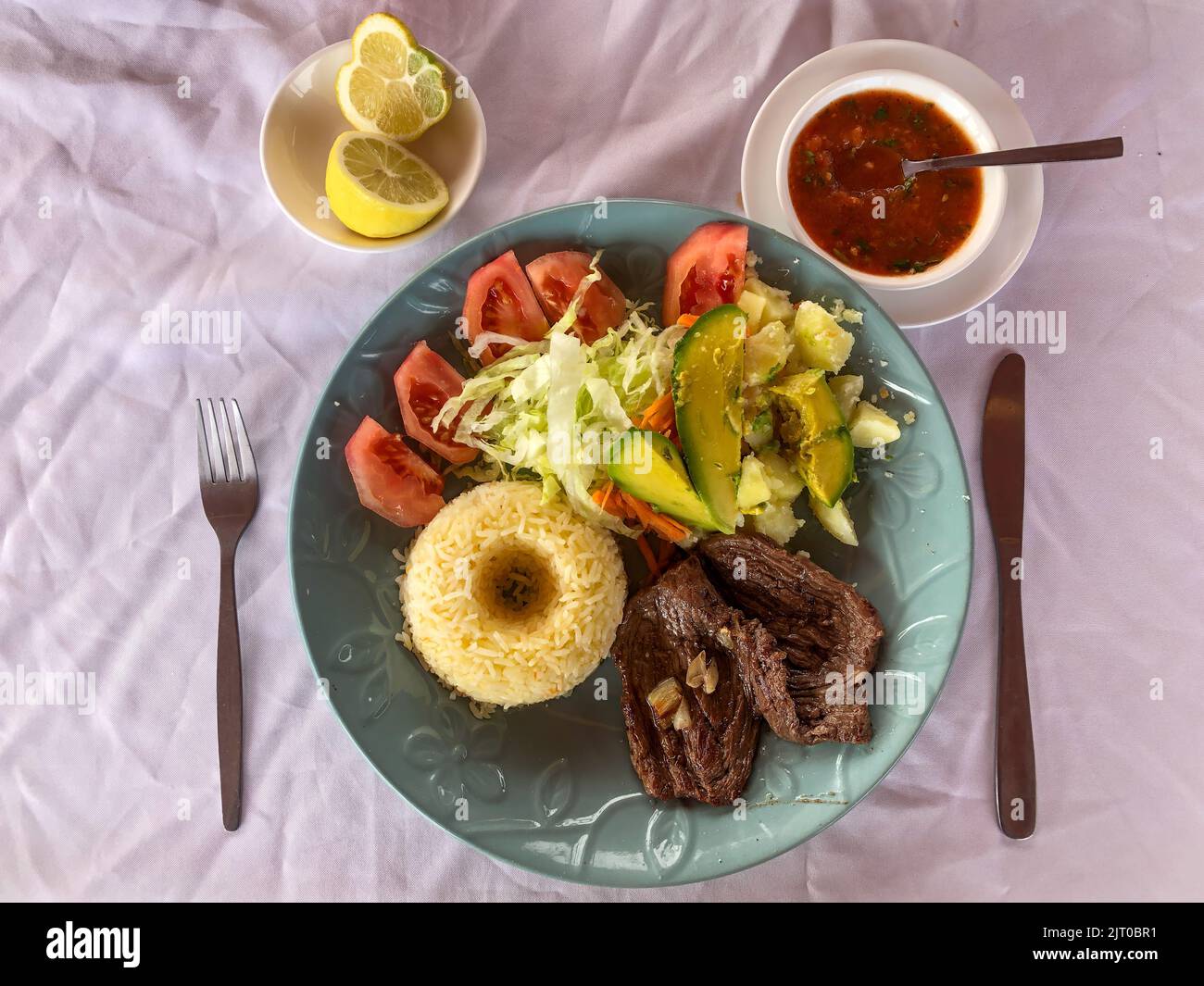 Flank steak with rice & salad with potatoes, lettuce, tomatoes
