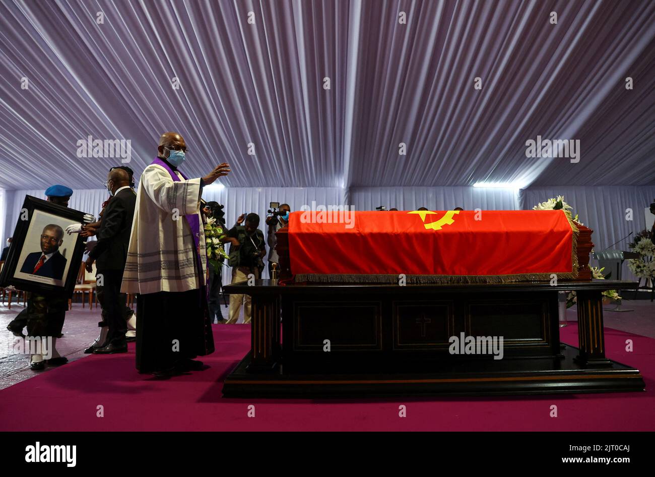 A priest blesses a casket carrying the body of Angola's former President Jose Eduardo dos Santos, who died in Spain in July, as it lies at the Agostinho Neto Memorial in Luanda, August 27, 2022. REUTERS/Siphiwe Sibeko Stock Photo