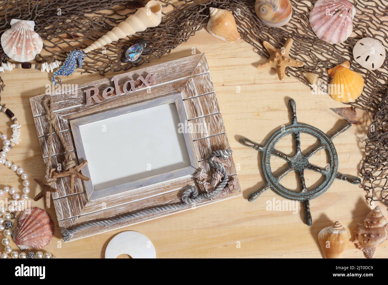 Empty Frame on Wood Background With Sea Shells and Fishing Net. Nautical and Coastal Theme Stock Photo