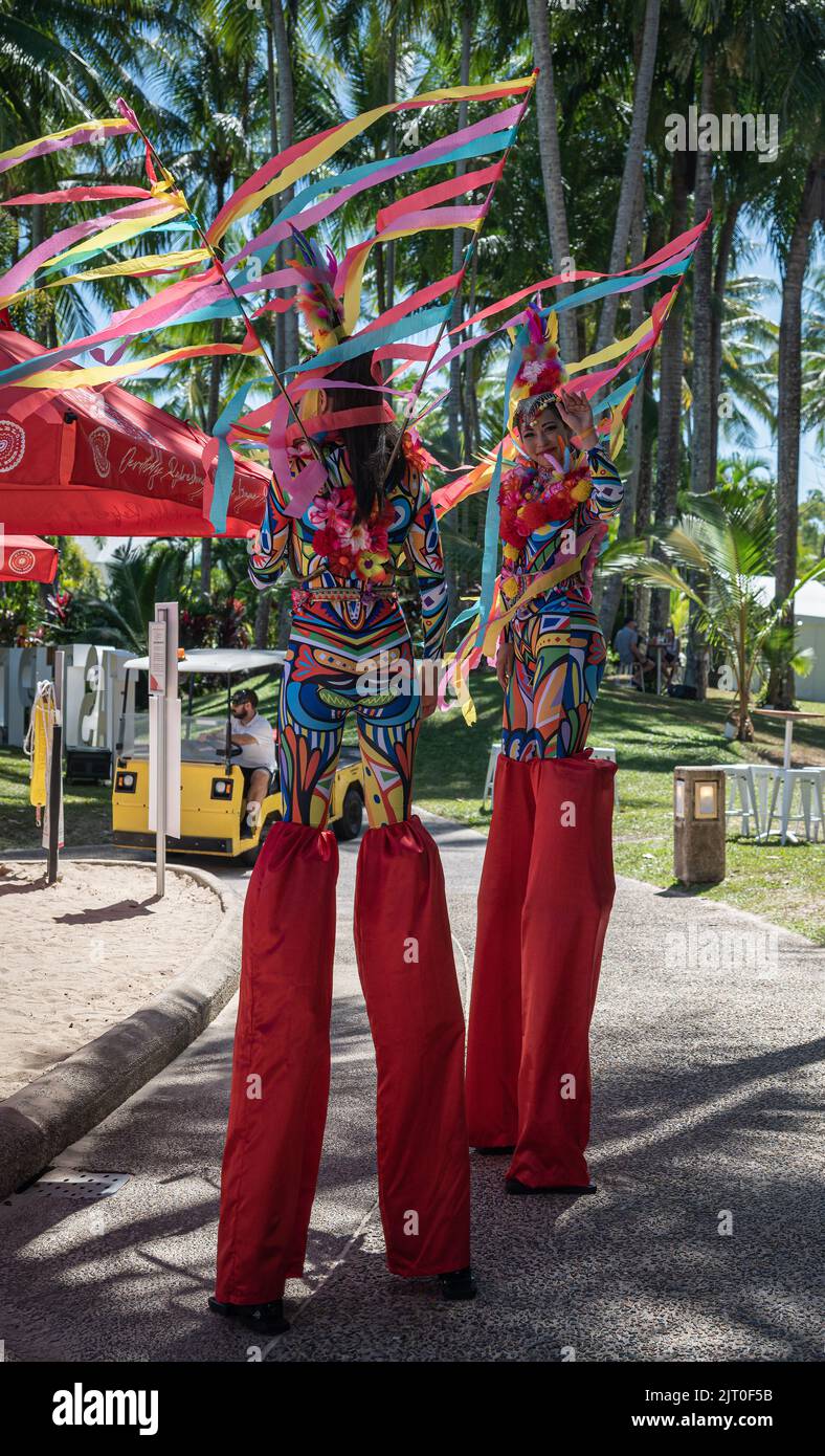 Two beautiful stilt-walker performers in colourful costume at the annual, 'Taste Port Douglas' Food and Drink festival in Queensland, Australia. Stock Photo
