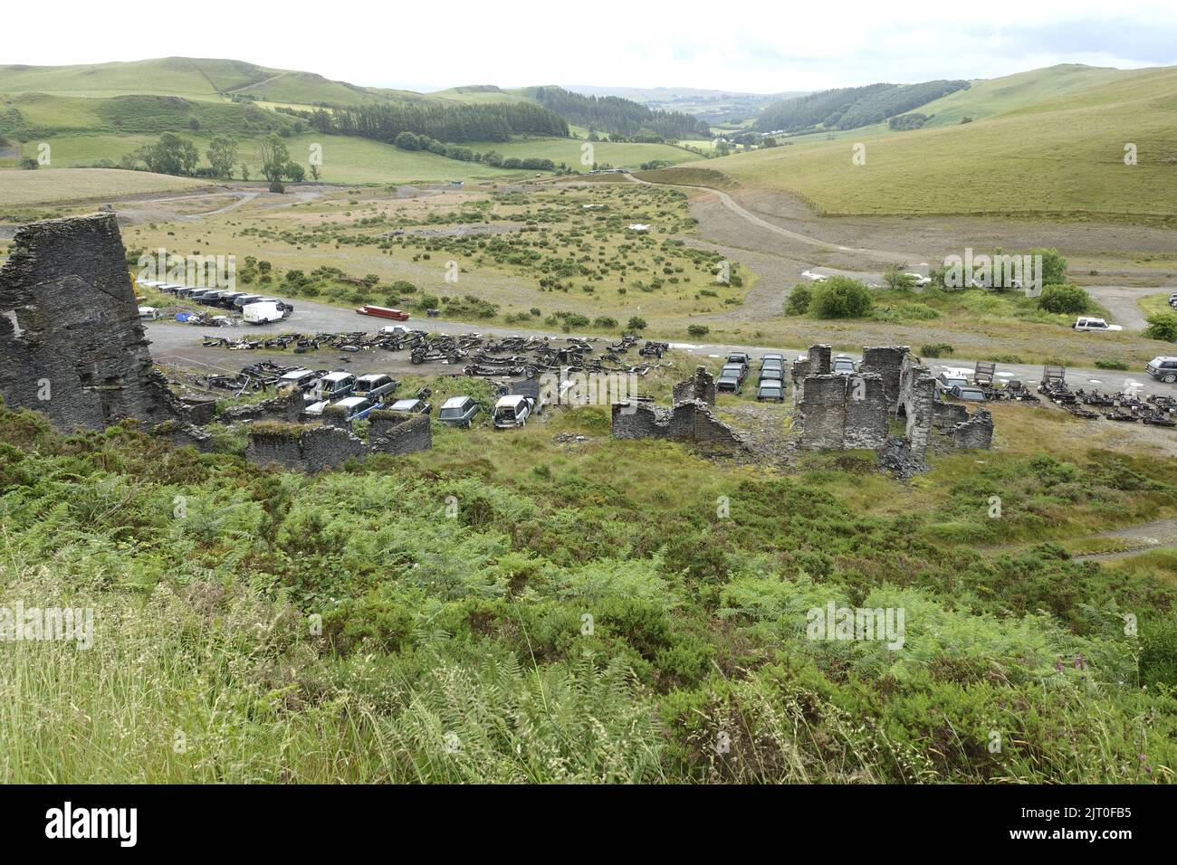 Large numbers of used Range Rovers on dismantling site in remote countryside near Trisant West Wales UK Stock Photo