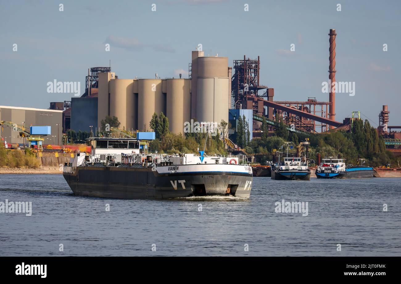 Duisburg, North Rhine-Westphalia, Germany - freighter at the southern harbor, Holcim cement plant at the back left, ThysseKrupp Steel blast furnace Sc Stock Photo