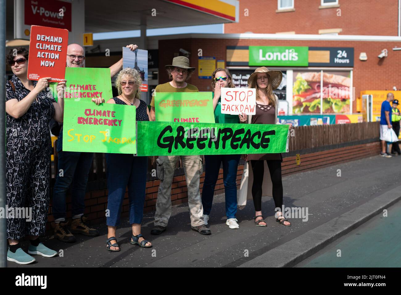 Manchester, UK. 27th Aug, 2022. Members of the environment group Greenpeace protest outside a Shell forecourt. The movement is trying to raise awareness of the proposed Jackdaw oilfield in the north sea which will only add to the climate emergency. Credit: Andy Barton/Alamy Live News Stock Photo