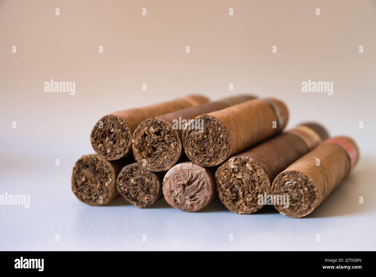 A small stack of various Cubans, Dominican Robustos, and corona cigars Stock Photo